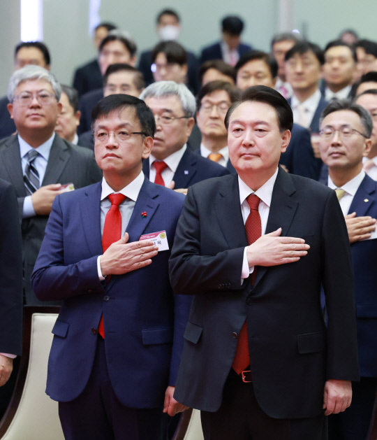 윤석열 대통령이 2일 오전 서울 영등포구 여의도 한국거래소에서 열린 2024 증권ㆍ파생상품시장 개장식에서 국기에 대한 경례를 하고 있다. 윤 대통령 왼쪽은 최상목 경제부총리 겸 기획재정부 장관. [연합뉴스]